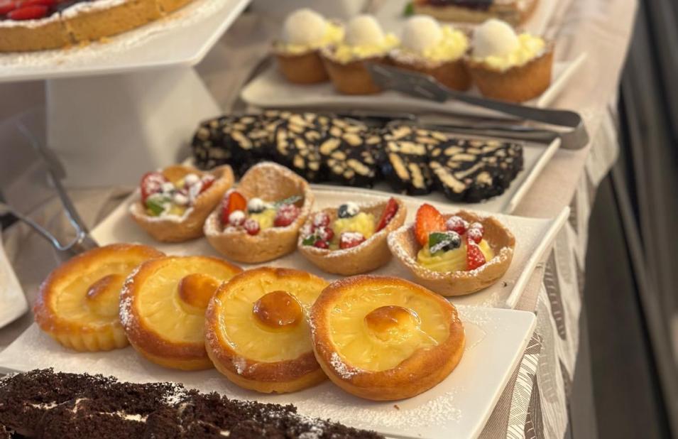 Dessert buffet with cakes, tarts, and various pastries.